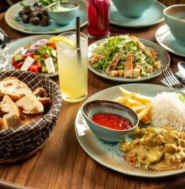 dinner-set-with-chicken-served-with-rice-french-fries-caesar-vegetable-salads-lemonade