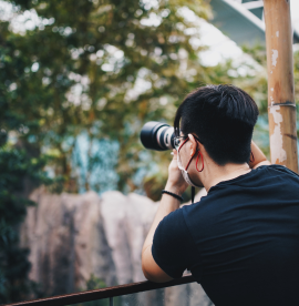 rear-view-man-photographing-standing-by-railing