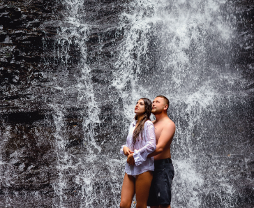 guy-and-girl-in-love-stand-under-a-waterfall